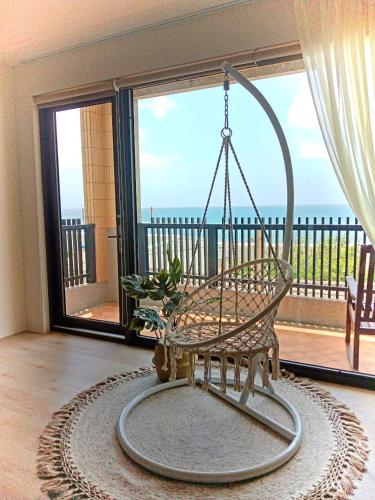 a swing in a living room with a balcony at Beachcastle & Sea View Villa in Magong
