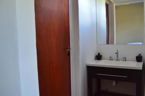 a bathroom with a sink and a mirror at Hotel Montana by CPH in Villa Carlos Paz