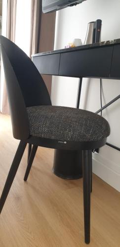a black chair sitting in front of a desk at Acacias Etoile in Paris
