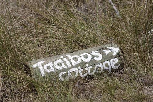 a sign laying in the grass in the field at Forest Hills in Knysna