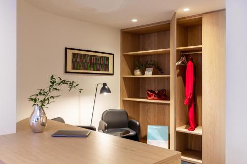 an office with a desk and a chair and a book shelf at Hotel Lago Di Garda in Nago-Torbole