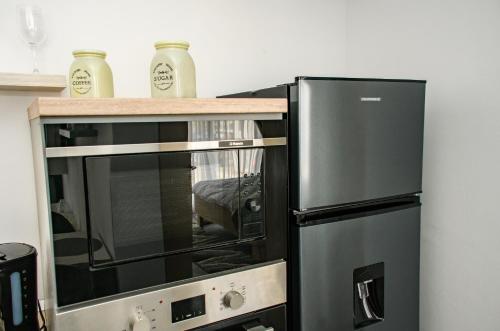 a microwave oven with a wooden counter on top of it at apart bun in Oradea