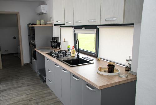 a kitchen with a counter and a counter top with a window at apart bun in Oradea