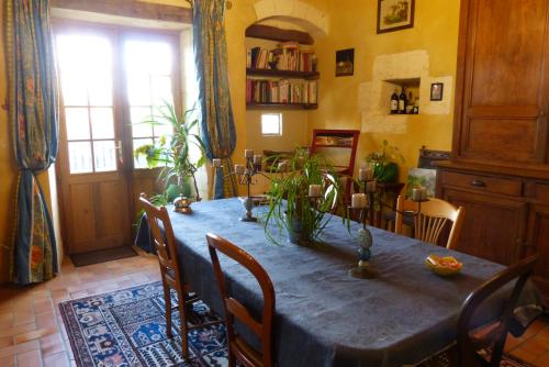 a dining room with a blue table and chairs at L'Echappée Belle Périgord in Cercles