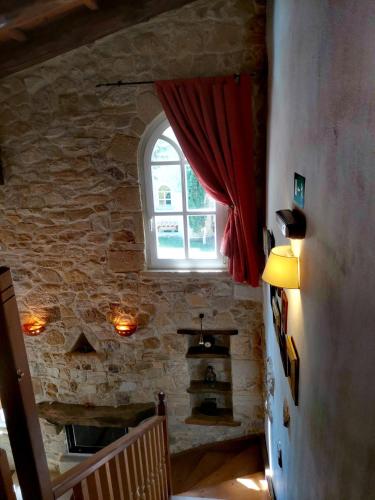 a room with a stone wall and a window at Rock House's Villa Melody in Plataniás