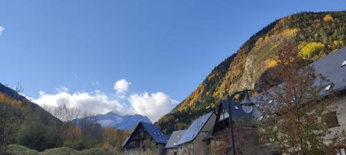 a group of houses in a valley with mountains at Arties Luxury Apartments - parking a pie de pistas Val de Ruda in Arties