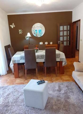 a dining room with a table with chairs and a couch at Casa Marciana in Geres