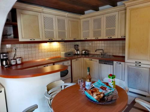 a kitchen with a table with a basket of food on it at Rock House's Villa Melody in Plataniás