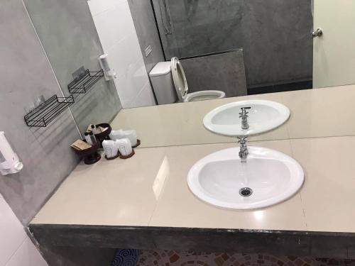 a bathroom with a white sink and a mirror at PTK BEACH in Chaweng