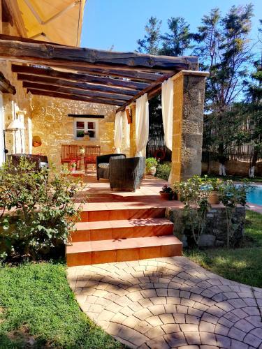 a patio with stairs leading to a house at Rock House's Villa Melody in Plataniás