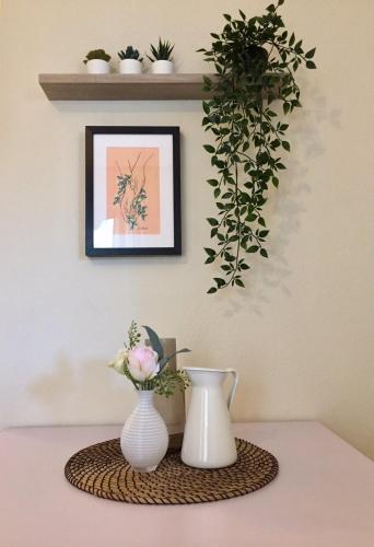 two vases on a table with a picture on the wall at Nikoletta's Studio 2 in Komotini