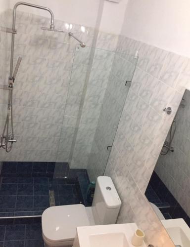 a bathroom with a toilet and a glass shower at Nikoletta's Studio 2 in Komotini