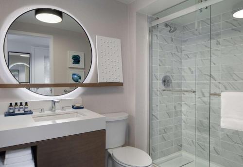 a bathroom with a shower and a toilet and a sink at Hyatt Regency Boston Harbor in Boston