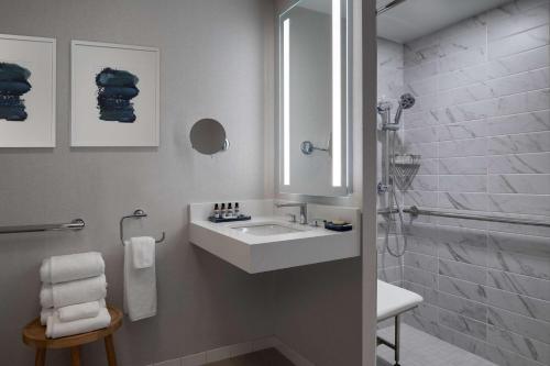 a white bathroom with a sink and a shower at Hyatt Regency Boston Harbor in Boston
