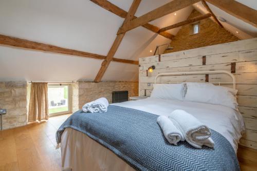 a bedroom with a bed with towels on it at Middle Barn in Dyrham