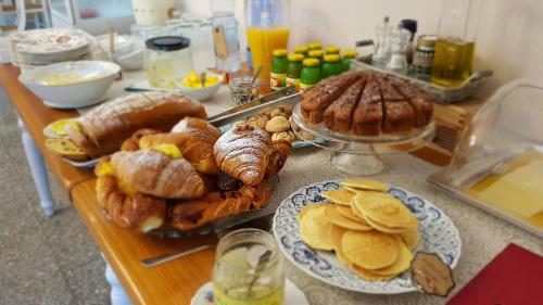 a table with many different types of bread and pastries at Villa Mandrioli in Cecina