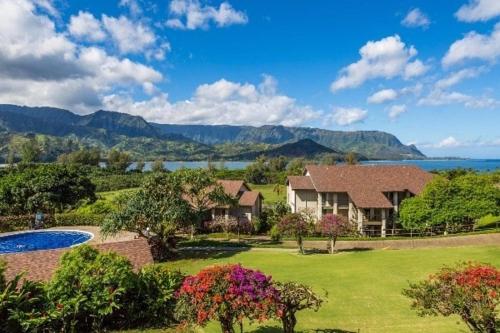 a large house with a yard with a swimming pool at Hanalei Bay Resort 6101 condo in Princeville
