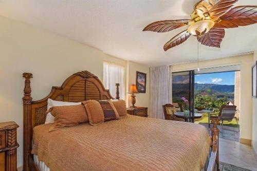 a bedroom with a bed and a ceiling fan at Hanalei Bay Resort 6101 condo in Princeville