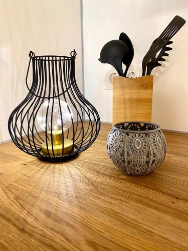 two vases and a vase on a wooden floor at Private Spa mit Sauna und Whirlpool in Schrozberg
