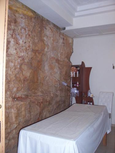 a room with a stone wall with a bed in it at Hotel Madonna Delle Grazie in Ceglie Messapica