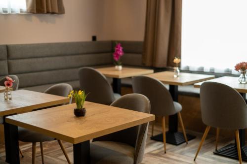 a room with tables and chairs with flowers on them at Villa Pino in Velingrad
