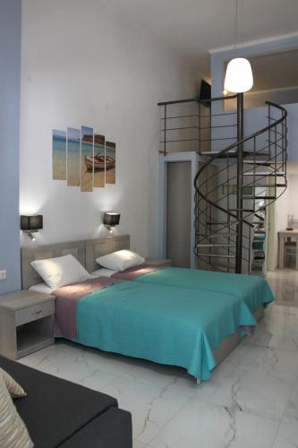 a bedroom with a bed and a spiral staircase at Lena Studios in in Hanioti