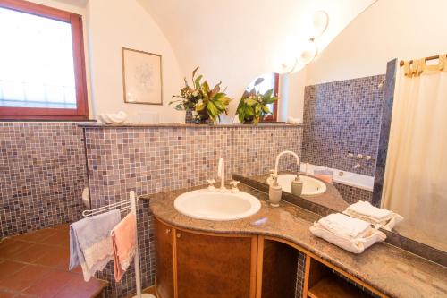 a bathroom with two sinks and a mirror at Podere Magnolia in Pisa