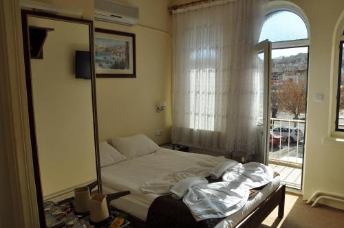 Postel nebo postele na pokoji v ubytování Cappadocia Kepez hotel