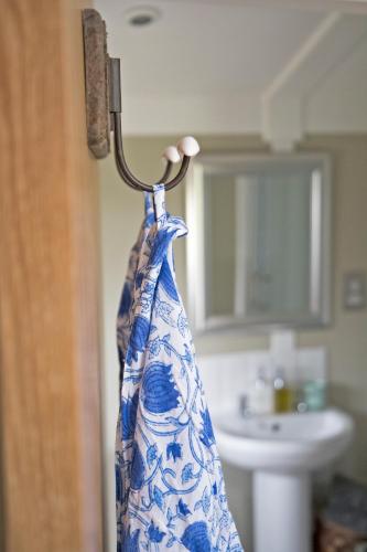 a towel hanging on a ring in a bathroom at Nether Farm Roundhouses - Henmore Water & Sturston Winds with hot tubs - Bradley Wood no hot tub in Ashbourne