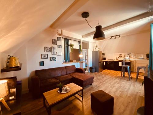 a living room with a couch and a table at Under Roof in Clermont-Ferrand