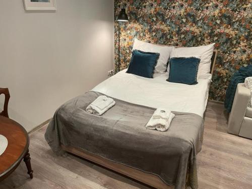 a bedroom with a bed with two towels on it at Apartment Chorzow Center in Chorzów