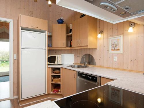 a kitchen with a white refrigerator and a sink at 8 person holiday home in Hemmet in Hemmet