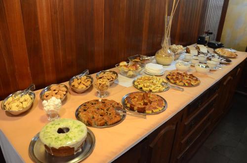 a table with many different types of food on it at Hotel Lenheiros in São João del Rei