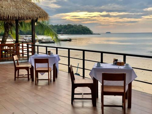 a restaurant with tables and chairs on the beach at Phi Phi Villa Resort in Phi Phi Don
