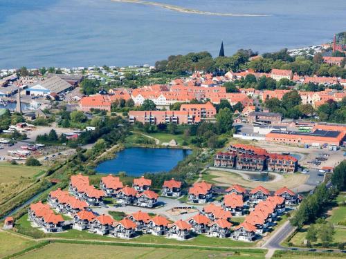 una vista aérea de una ciudad con casas y un lago en 5 person holiday home on a holiday park in Bogense en Bogense
