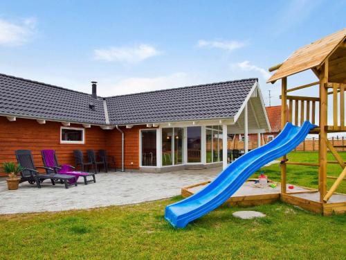 um quintal com escorrega e um parque infantil em 14 person holiday home in Sydals em Høruphav
