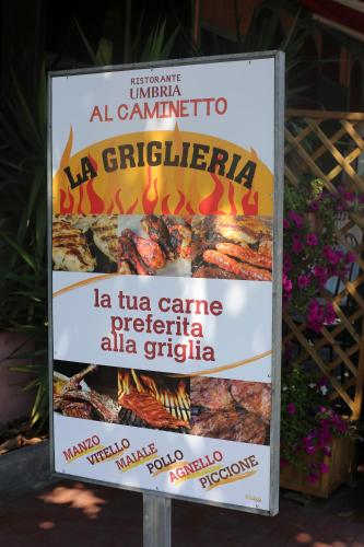 a sign for a restaurant with grilled meat at Hotel Ristorante Umbria in Orvieto