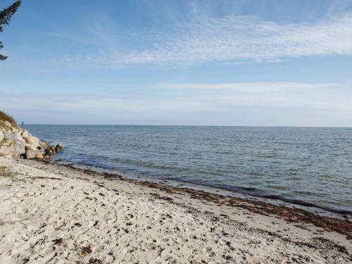 a sandy beach with the ocean in the background at Luxury Beach House with Spa - By Traum Ferienwohnungen in Hals