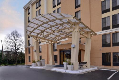 a large building with a metal canopy in front of it at Holiday Inn Express Hunt Valley by IHG in Hunt Valley