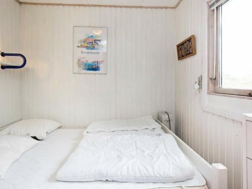 a white bedroom with two beds in it at Three-Bedroom Holiday home in Karrebæksminde 1 in Karrebæksminde