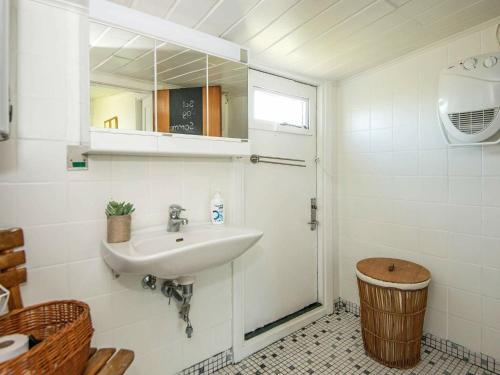 a bathroom with a sink and a mirror and a shower at 4 person holiday home in Broager-By Traum in Broager