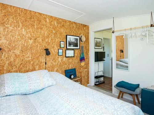 a bedroom with a bed in a room with a wall at 4 person holiday home in Broager-By Traum in Broager