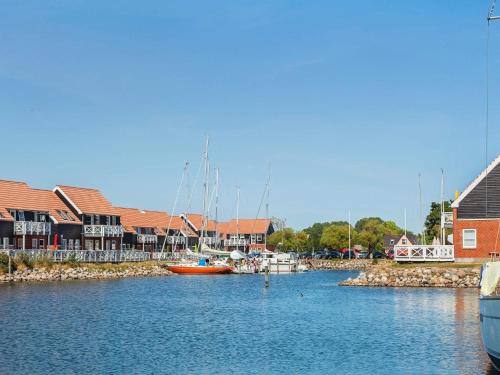 a marina with boats in the water and buildings at 6 person holiday home on a holiday park in Borre in Borre