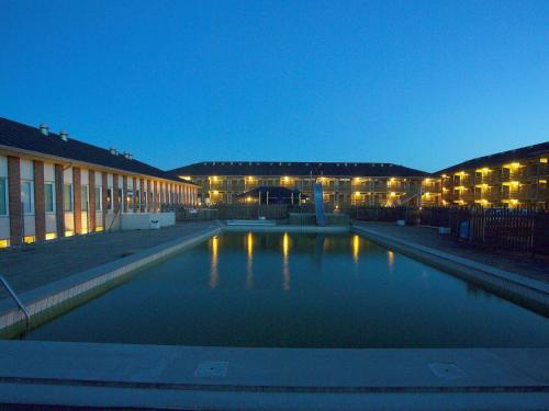 a large pool of water in front of a building at Apartment Fanø VII in Fanø