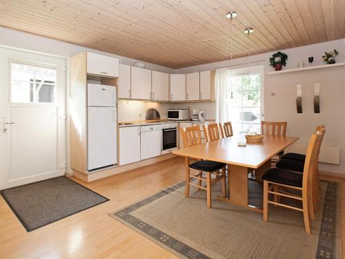 a kitchen and dining room with a table and chairs at 6 person holiday home on a holiday park in Gråsten in Gråsten