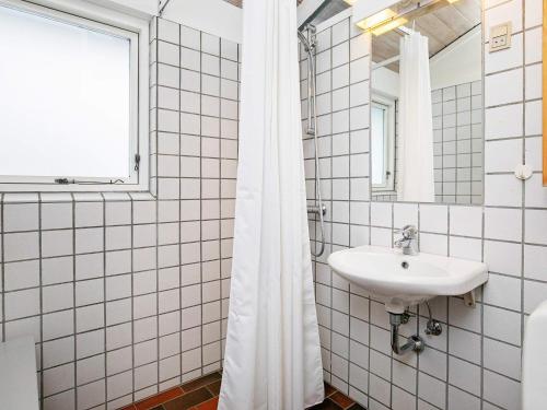 a white bathroom with a sink and a window at Vigsø Holiday Center- Type 7 in Hanstholm