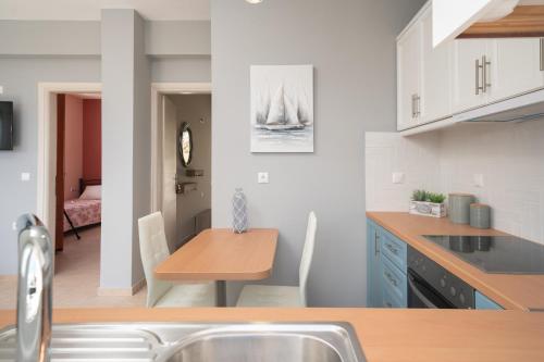 a kitchen with a table and a dining room at Seaside Euphoria Kefalonia in Ayia Evfimia