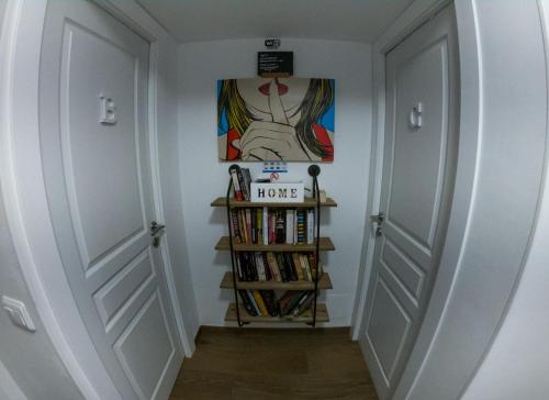 a hallway with two doors and a book shelf at Beach Inn in Port d'Alcudia