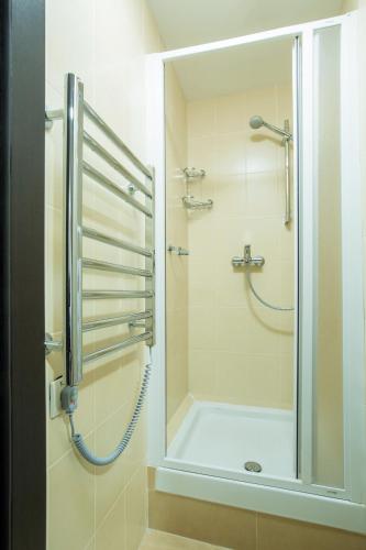 a bathroom with a shower with a glass door at 7 Days City Hotel in Dnipro