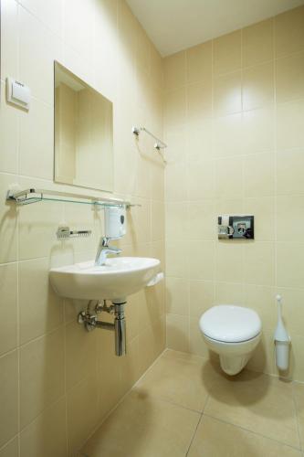 a bathroom with a sink and a toilet at 7 Days City Hotel in Dnipro